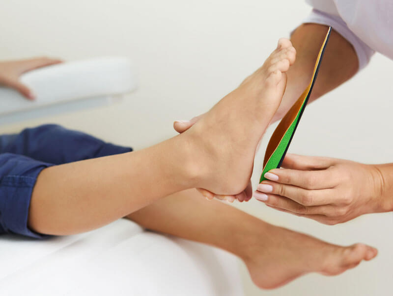 Custom orthotic being fitted to someones foot